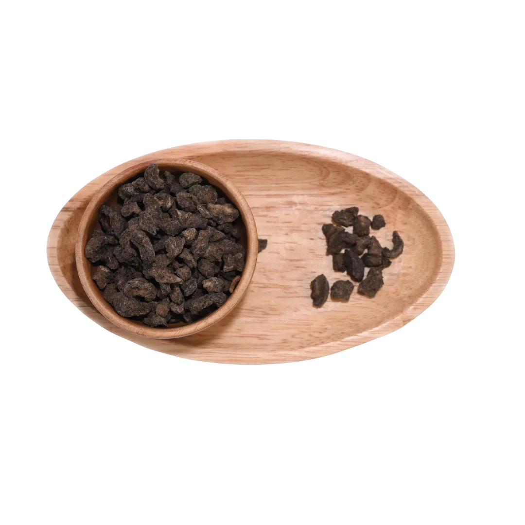Top view of Amla Salted Dried pieces in a wooden bowl on a natural surface