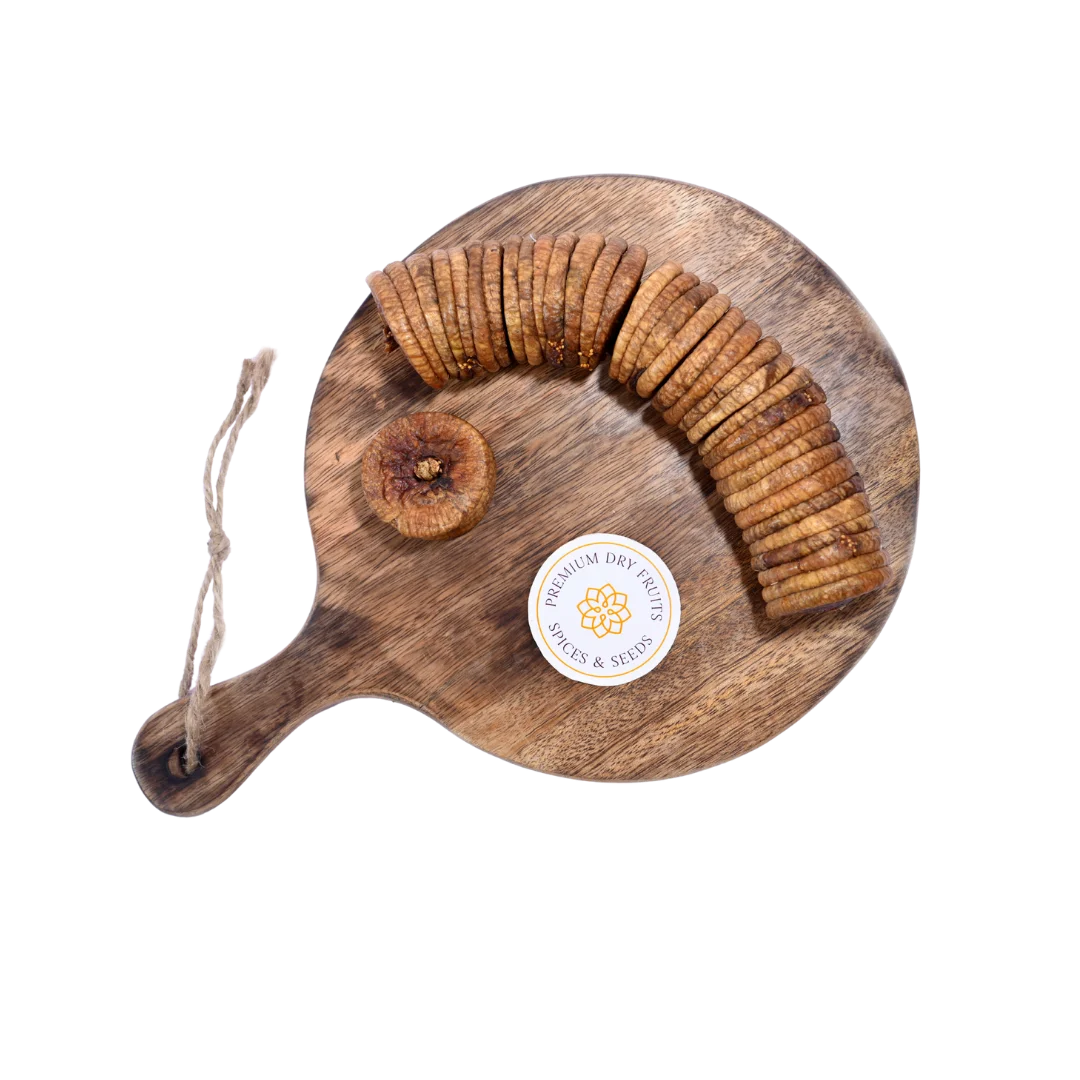 Close-up of Dry Figs Standard Anjeer on a wooden surface, highlighting freshness and natural wrinkles.