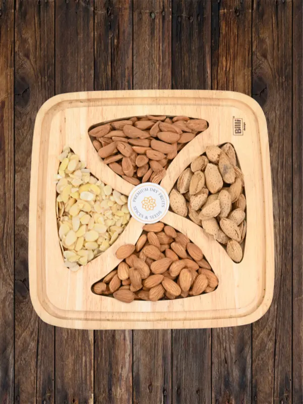 Assorted almond varieties including whole, sliced and shell almonds displayed on wooden tray by House of Rasda
