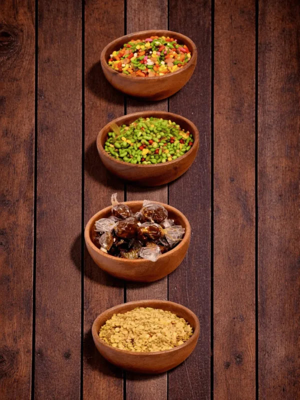 Indian mouth freshener (Mukhas) in wooden bowls – Poona Mix, Green Mix, Tamarind Candy and Roasted Coriander Seeds