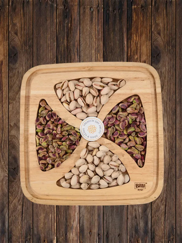 Premium pistachio gift tray with salted pista kernels and whole pistachios on wooden board by House of Rasda.