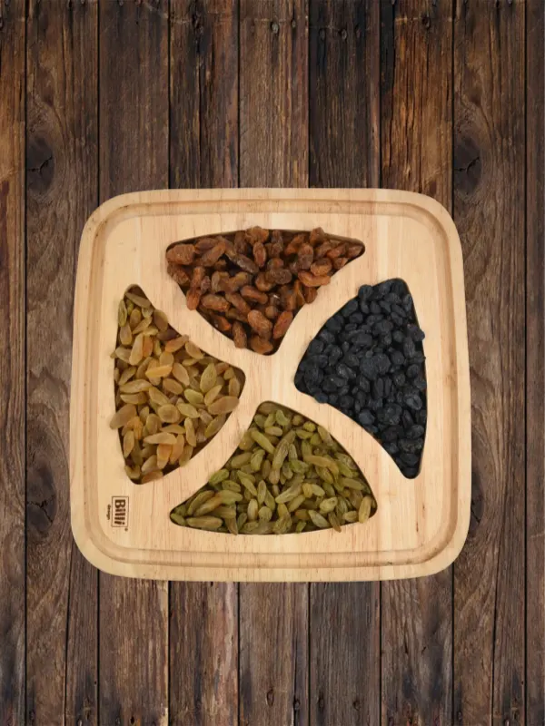 Assorted premium raisins including green, black and brown varieties displayed on wooden tray by House of Rasda.