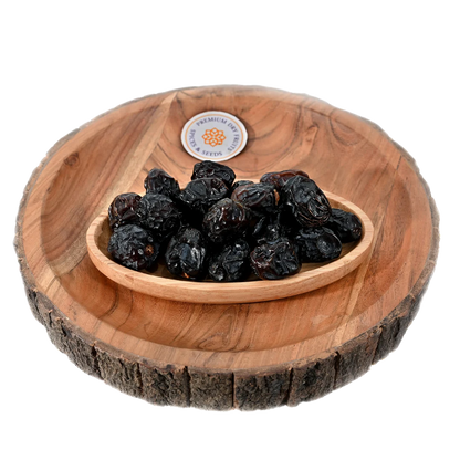 Saudi Premium Ajwa Dates served in wooden bowl soft chewy dates rich in antioxidants and minerals