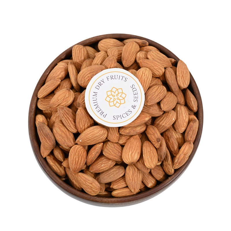 A cozy kitchen setting featuring a wooden bowl filled with almonds jumbo  and scattered nuts around it.