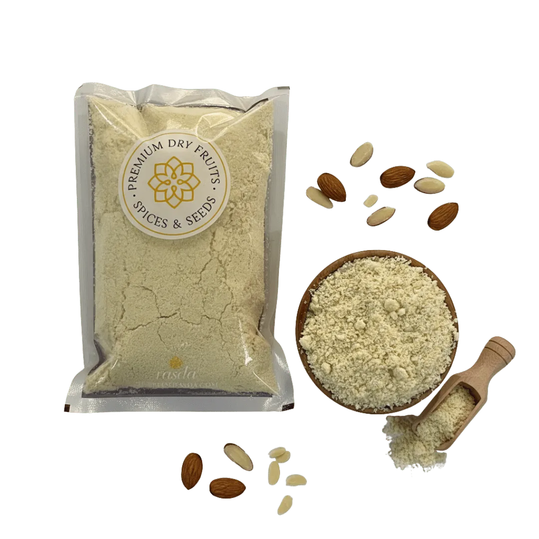 Packaged premium Blanched Almond Flour and spices with a bowl of ground powder and almonds on a white background.
