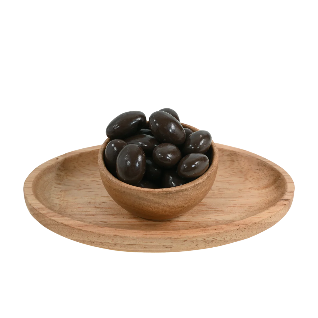 Premium Almonds Chocolate Coated Badam on rustic surface – delicious protein rich nuts with sweet chocolate layer for energy