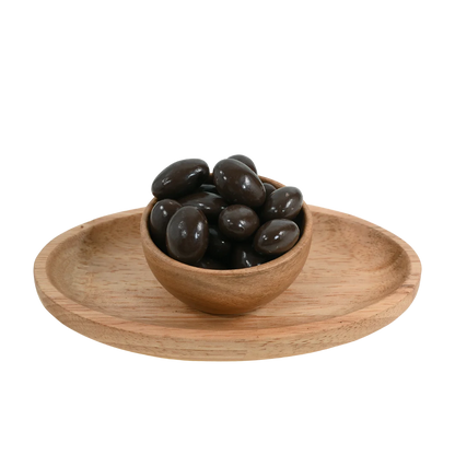 Premium Almonds Chocolate Coated Badam on rustic surface – delicious protein rich nuts with sweet chocolate layer for energy