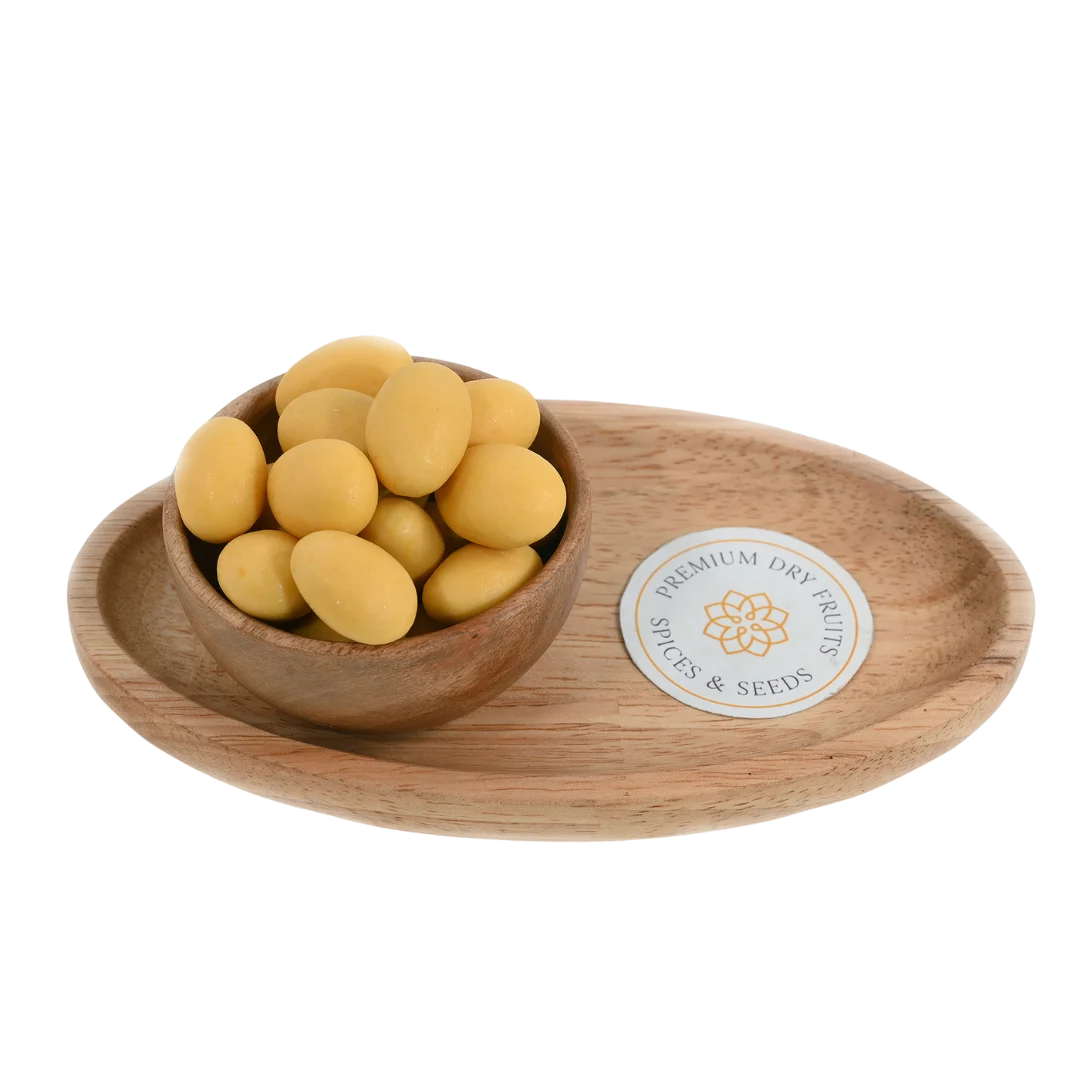 Almonds Mango Chocolate Coated Badam in wooden bowl – roasted almonds covered in smooth mango flavored chocolate for fruity healthy snacking