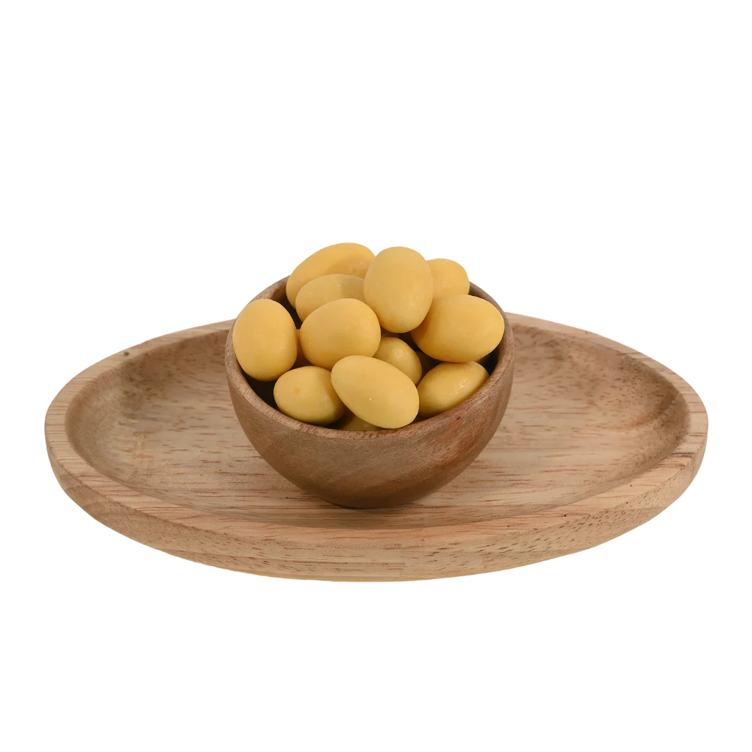 Premium Almonds Mango Chocolate Coated Badam on rustic background – sweet tropical flavored dry fruits packed with energy and taste