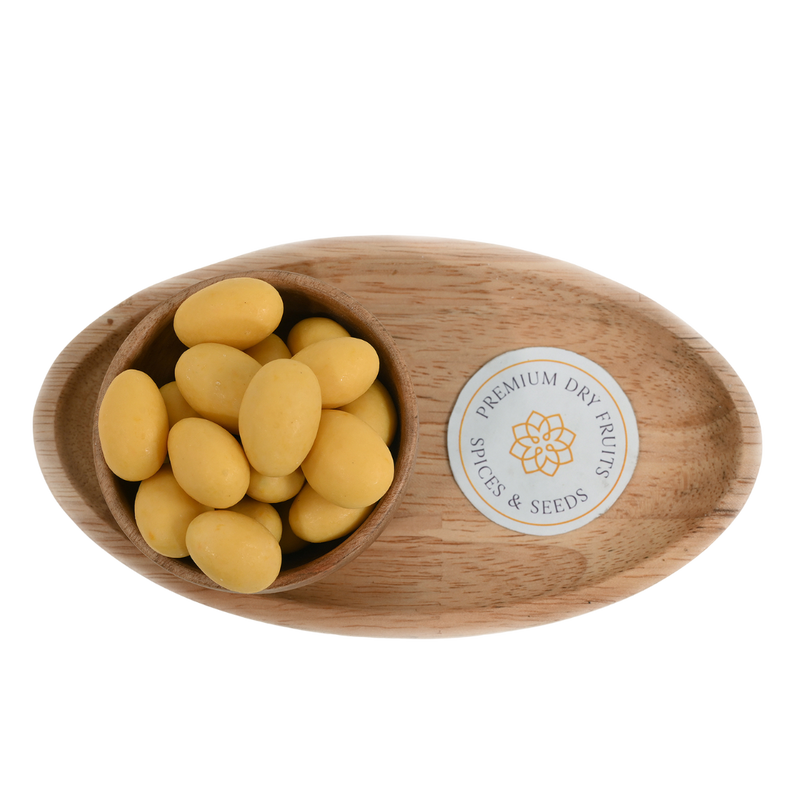Artistic display of Almonds Mango Chocolate Coated in a handcrafted wooden bowl, capturing the blend of crunchy almonds, velvety chocolate, and bright mango accents.