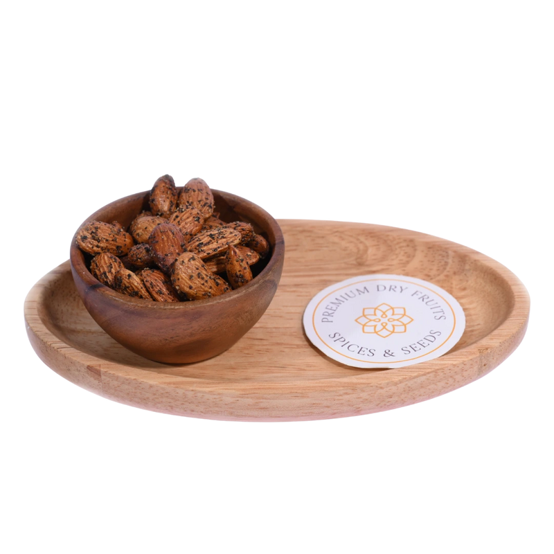 Wooden bowl with Almonds Pepper Spiced on a wooden tray with a label, on a white background 