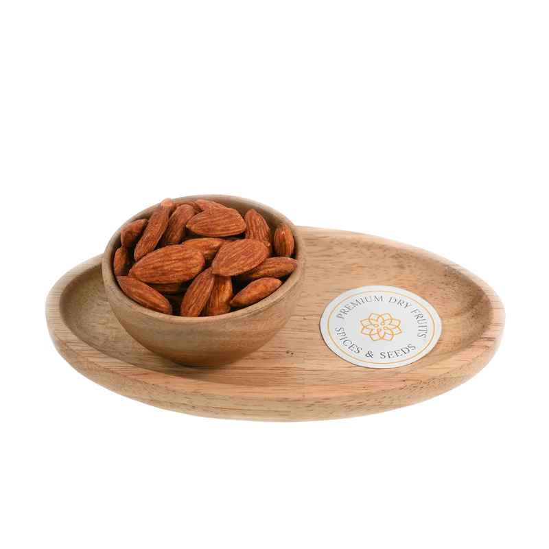 Wooden bowl with Almonds Peri Peri Spiced on a wooden tray with a visible brand label on a white background