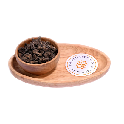 Rustic bowl filled with Amla Salted Dried placed on a wooden table