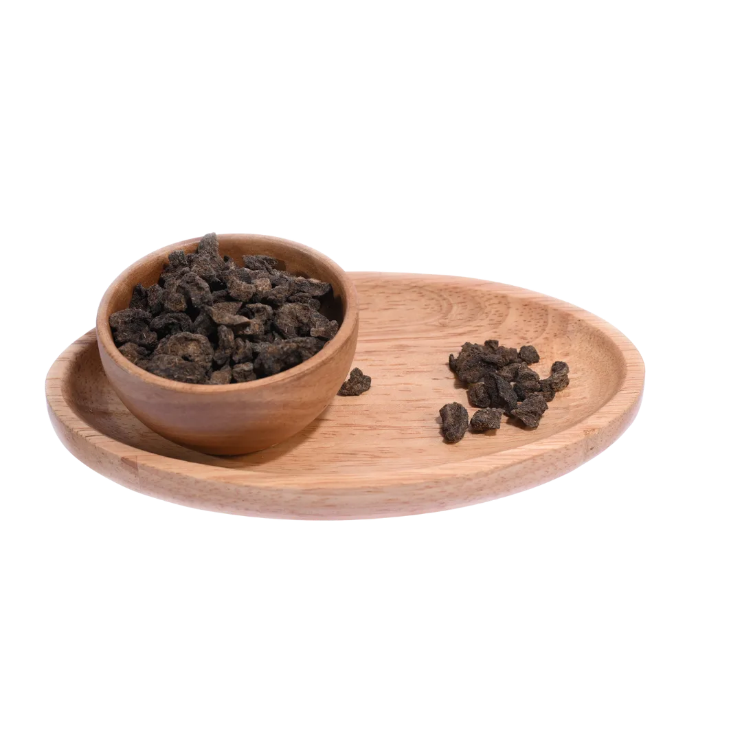 Amla Salted Dried pieces spilling out of a bowl, showcasing their dry and tangy appearance