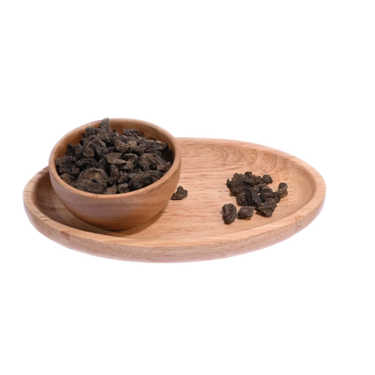 Amla Salted Dried pieces spilling out of a bowl, showcasing their dry and tangy appearance