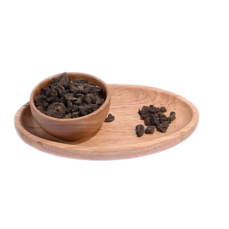 Amla Salted Dried pieces spilling out of a bowl, showcasing their dry and tangy appearance