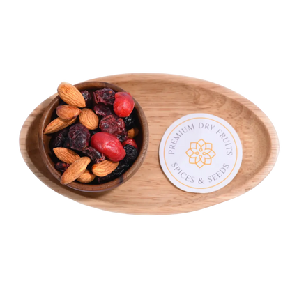Antioxidant Trail Mix Wooden bowl with almonds and dried fruits on a wooden tray with a label.
