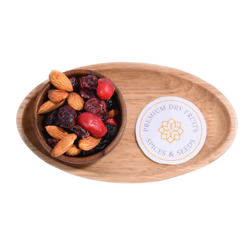 Antioxidant Trail Mix Wooden bowl with almonds and dried fruits on a wooden tray with a label.
