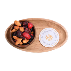 Antioxidant Trail Mix Wooden bowl with almonds and dried fruits on a wooden tray with a label.