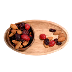 Antioxidant Trail Mix Wooden bowl and tray with almonds and dried fruits on a white background