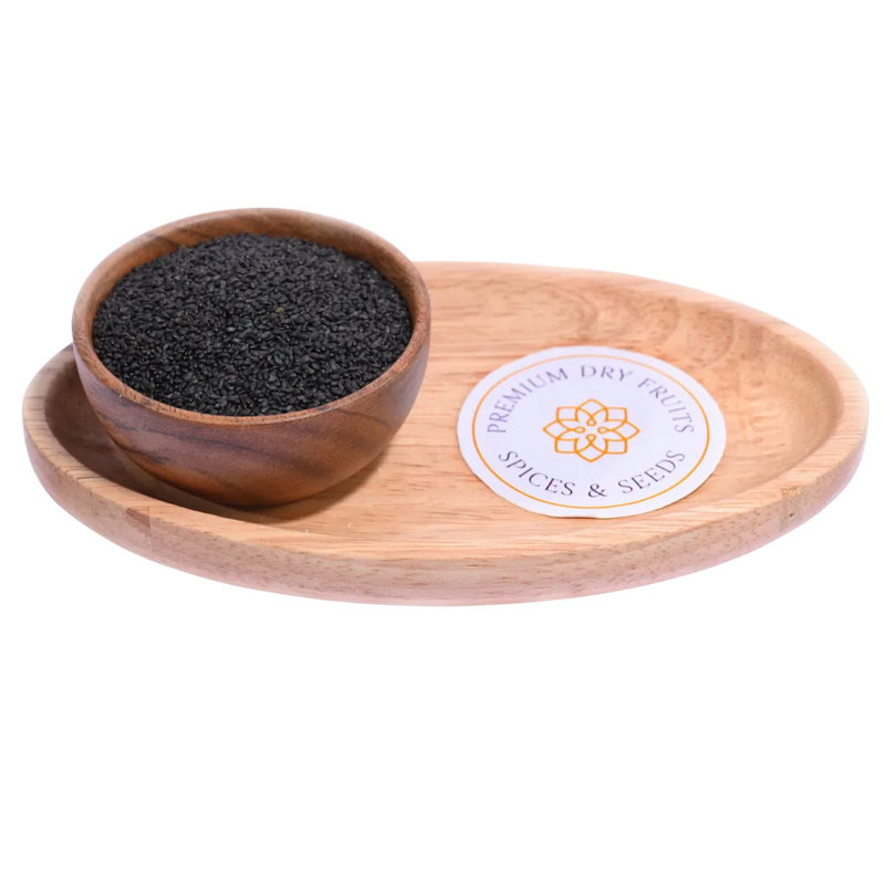 Tiny black Basil Seeds / Sabja Seeds displayed in a wooden bowl, highlighting their glossy surface and natural texture.