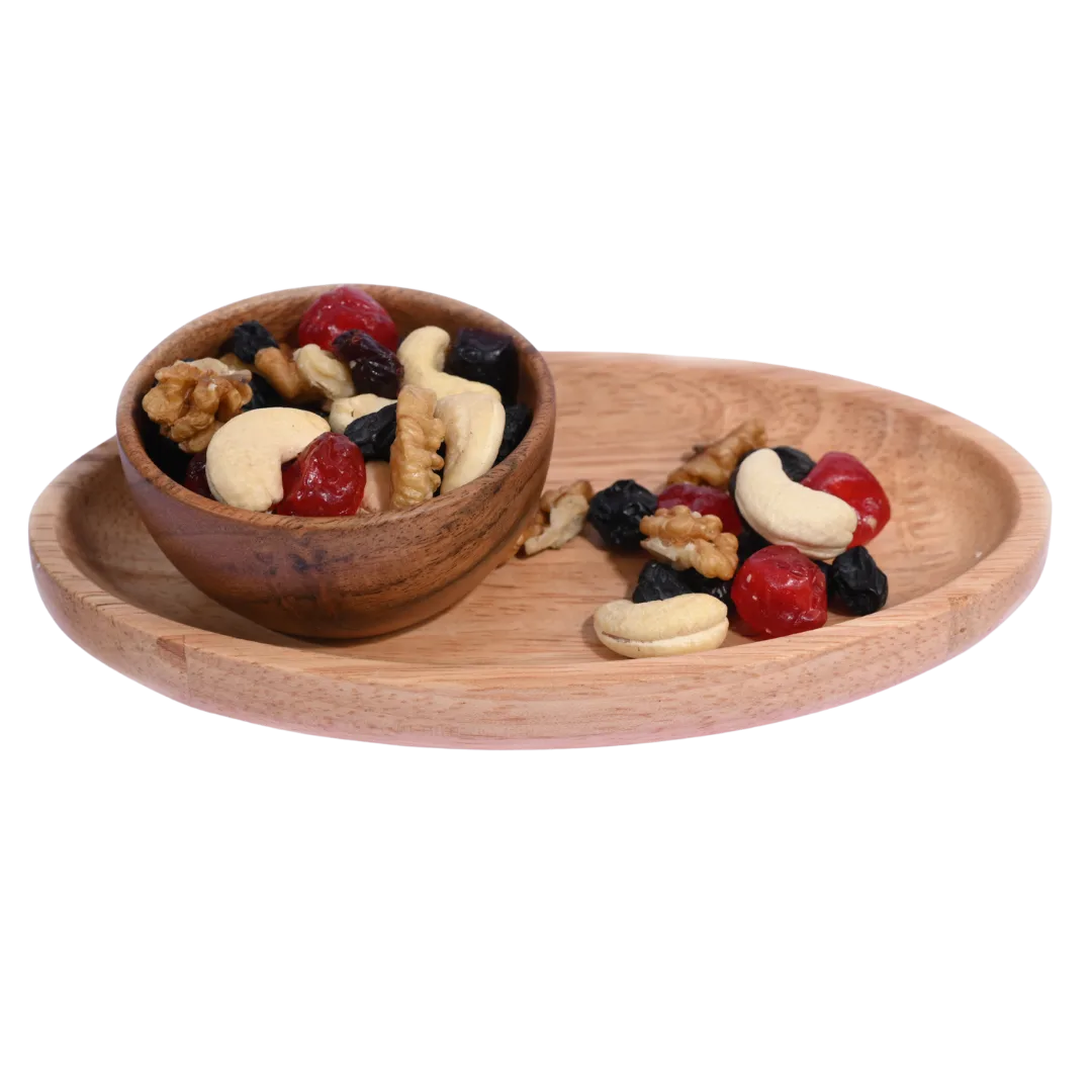 Wooden bowl and tray with mixed nuts and dried fruits on a white background. Berry Nutty Trail Mix