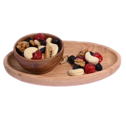 Wooden bowl and tray with mixed nuts and dried fruits on a white background. Berry Nutty Trail Mix