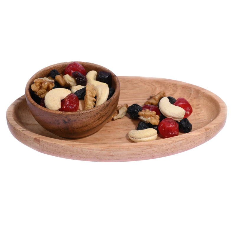 Wooden bowl and tray with mixed nuts and dried fruits on a white background. Berry Nutty Trail Mix