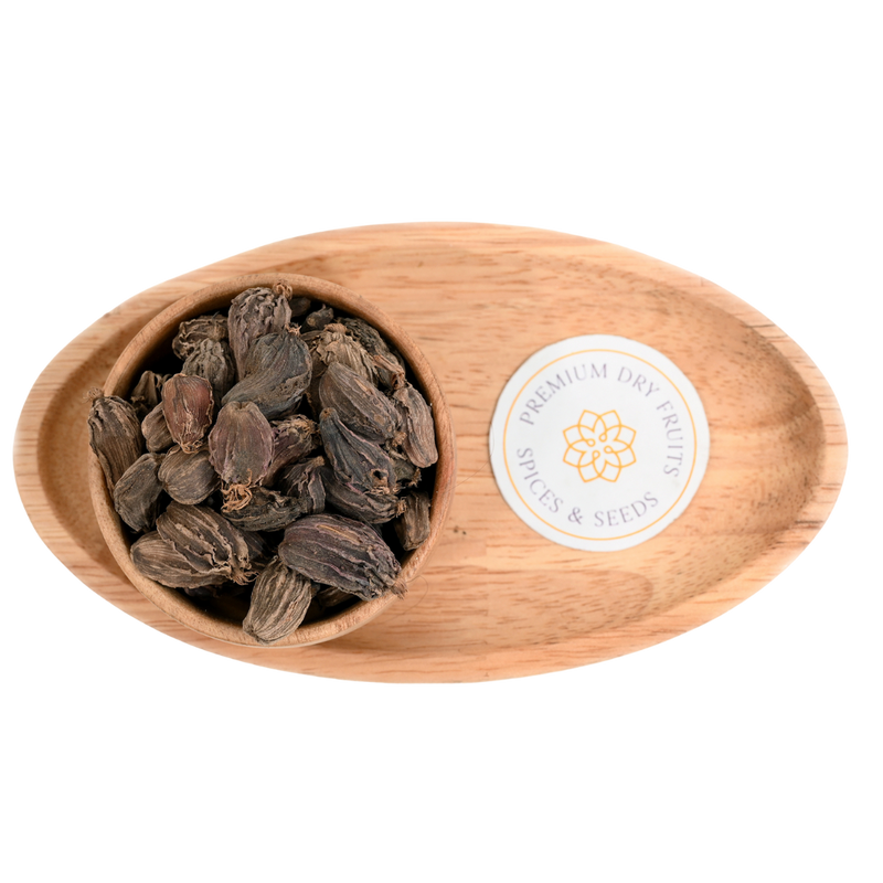 Close-up of whole black cardamom pods, showcasing their wrinkled, dark brown exterior with woody textures