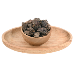 A handful of black cardamom pods, large and rough, with visible ridges and earthy tones.