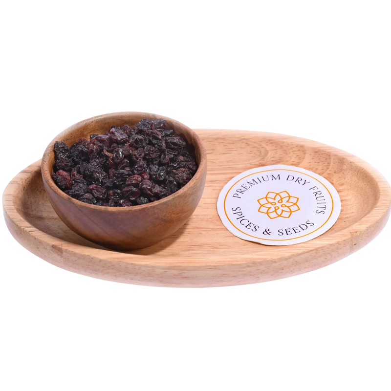 Wooden bowl with dried fruits on a wooden tray - Black Currants Dried Premium