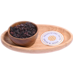 Wooden bowl with dried fruits on a wooden tray - Black Currants Dried Premium