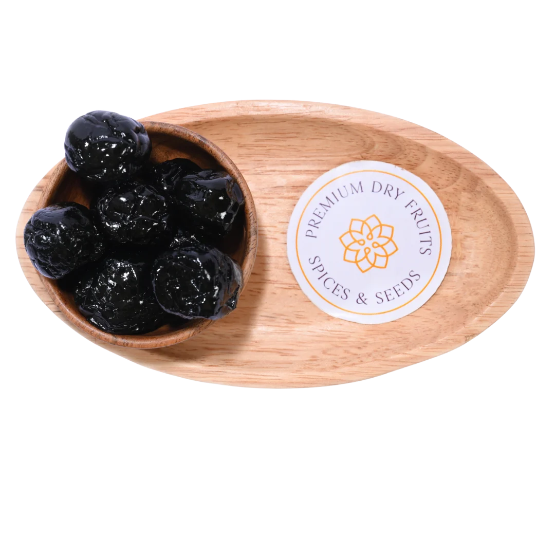 Close-up view of Black Plums Dehydrated arranged in a round wooden bowl.