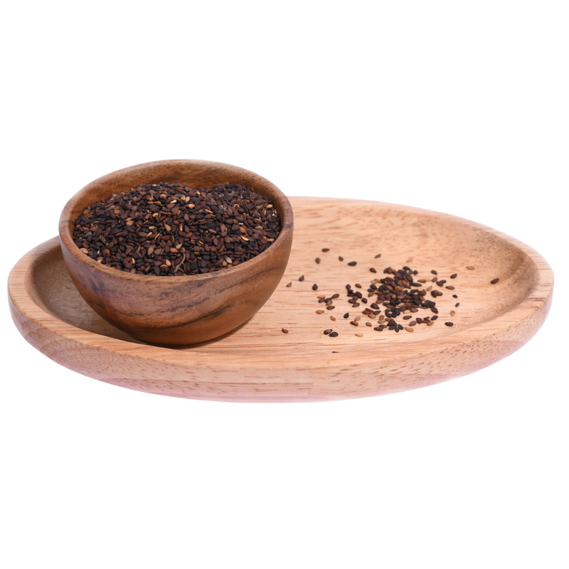 A wooden bowl filled with black sesame seeds, showing their smooth