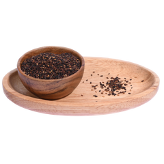 A wooden bowl filled with black sesame seeds, showing their smooth