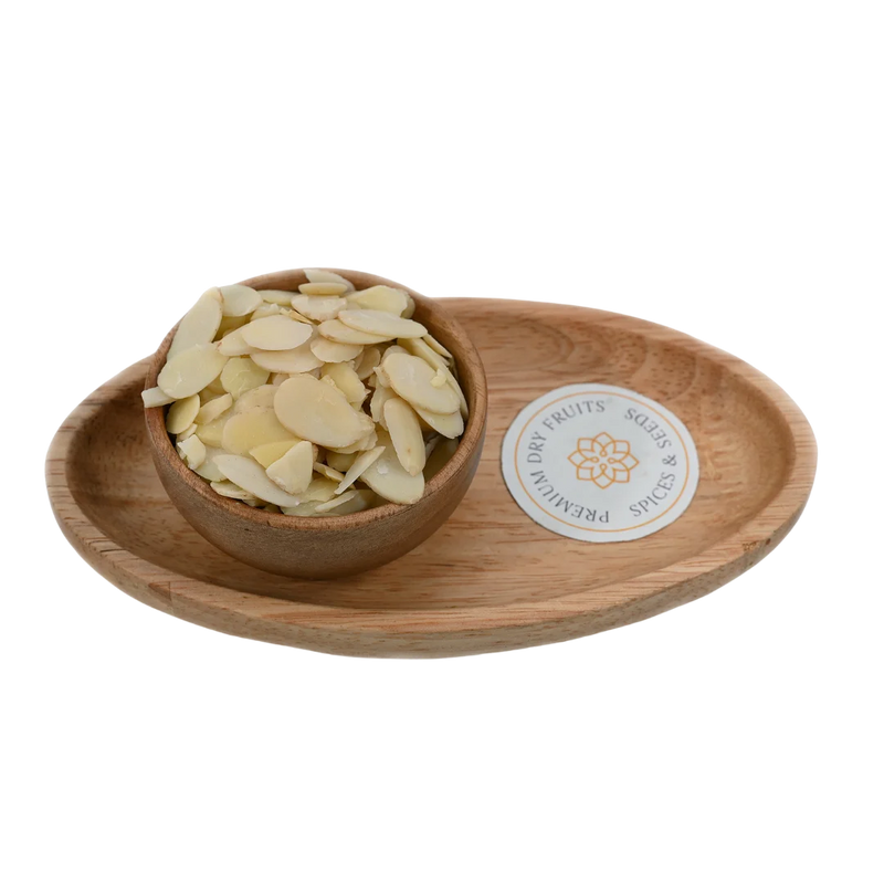 Blanched Sliced Almonds Badam in wooden bowl – premium thin almond flakes rich in protein and vitamin E for healthy snacking