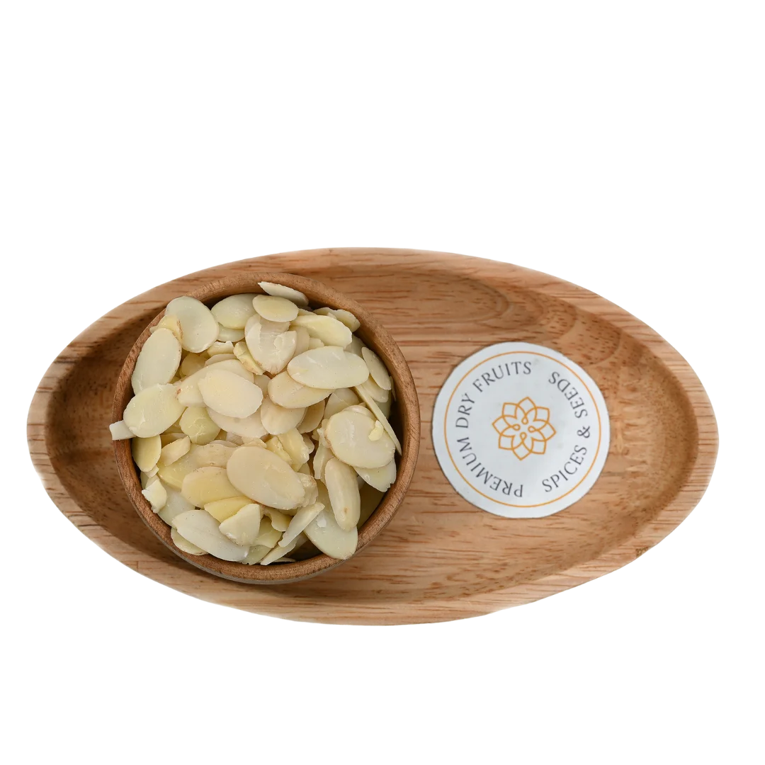 Crunchy Blanched Sliced Almonds Badam on wooden surface – natural gluten free almond flakes for desserts and baking recipes