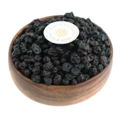 Blueberries Dried Whole Premium in a wooden bowl, showcasing their deep blue color and glossy finish.