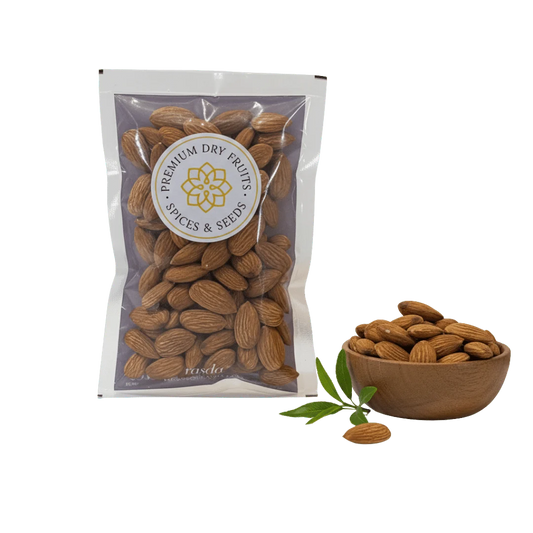 Packaged California Almonds with a bowl of almonds and a leaf on a white background