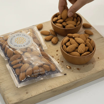 California Almonds Jumbo  in a package and two wooden bowls on a wooden board.