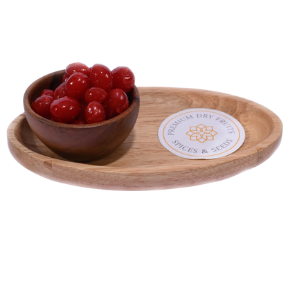 Bright red Candied Cherries/ Glace Cherries in a wooden bowl, showcasing their glossy, syrup-coated texture.