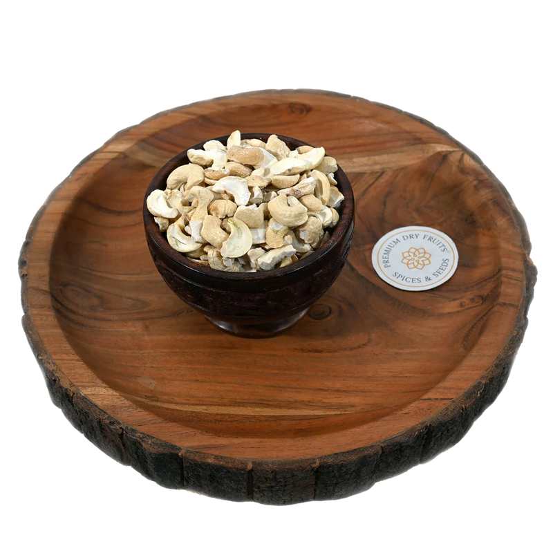 Fresh big cashew pieces displayed in a wooden bowl, buy premium dry fruits online in Bangalore from House of Rasda, perfect for sweets and desserts.