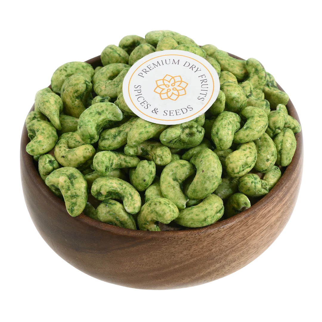Crunchy green chilli spiced cashews in wooden bowl - tangy heat flavoured snack