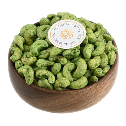 Crunchy green chilli spiced cashews in wooden bowl - tangy heat flavoured snack