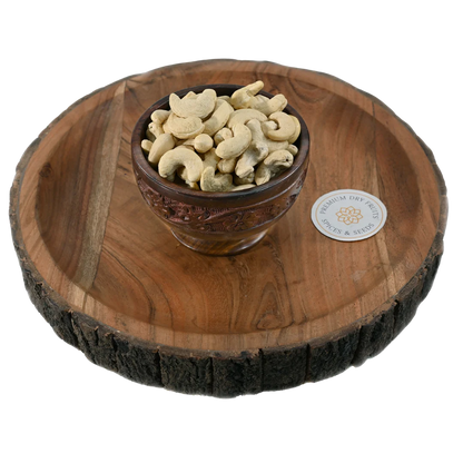 Fresh cashew nuts with smooth texture and natural cream colour, served in a wooden bowl, ideal for snacking and cooking, available to buy online from House of Rasda in Bangalore.