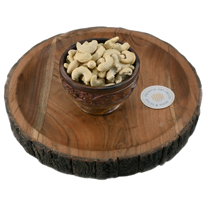 Fresh cashew nuts with smooth texture and natural cream colour, served in a wooden bowl, ideal for snacking and cooking, available to buy online from House of Rasda in Bangalore.