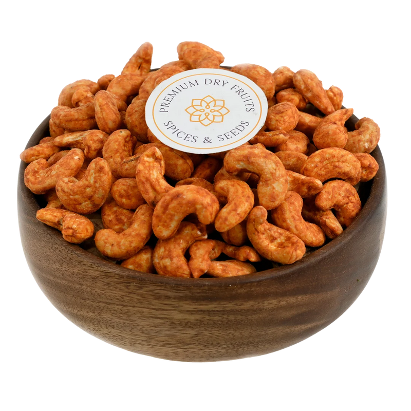 Fiery peri peri spiced cashew nuts served in a wooden bowl, buy flavoured cashews online in Bangalore from House of Rasda, perfect for bold and zesty snacking.