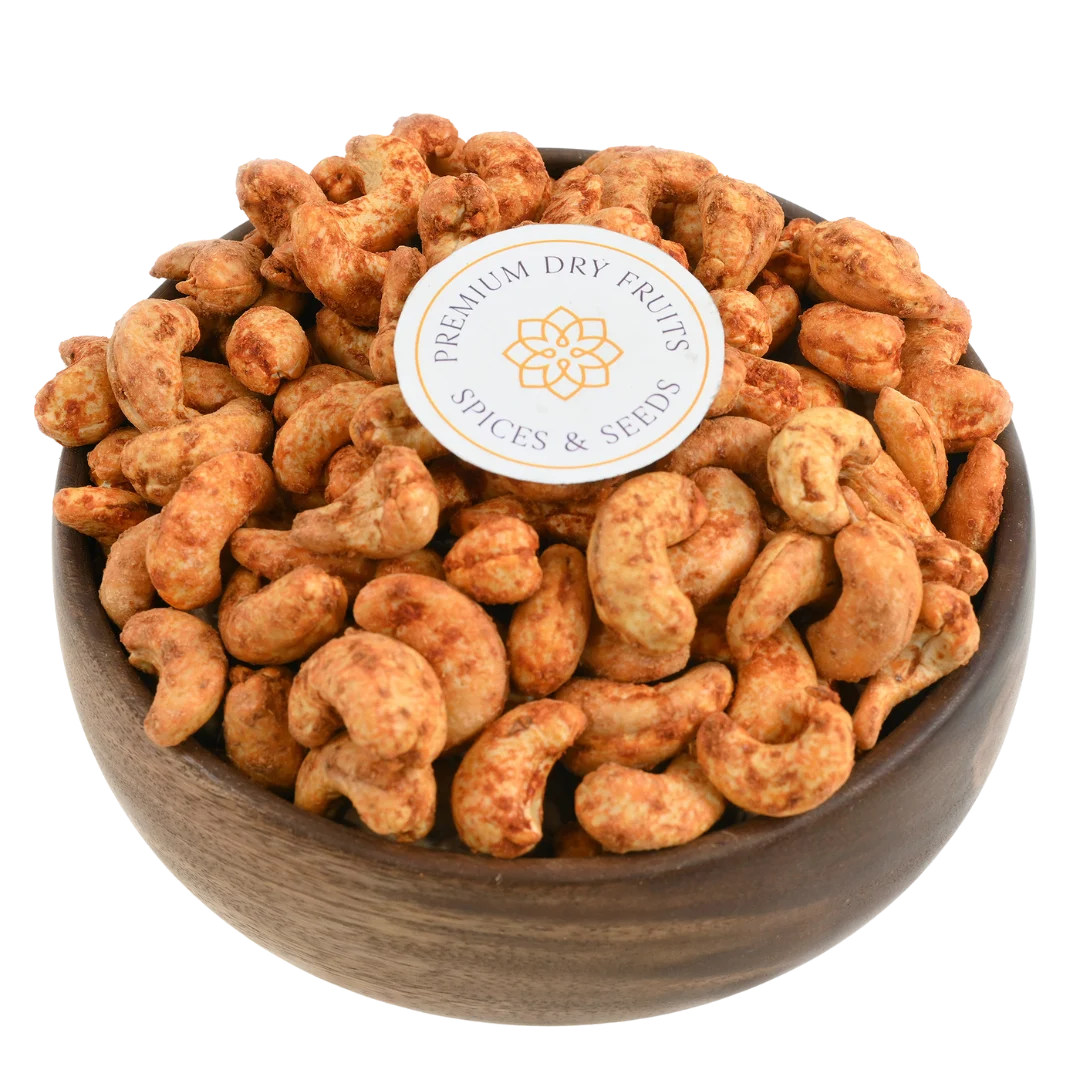 Fiery red chilli spiced cashew nuts in wooden bowl - bold flavour crunchy snack