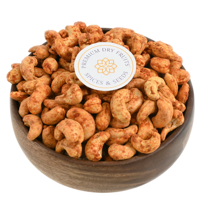 Fiery red chilli spiced cashew nuts in wooden bowl - bold flavour crunchy snack