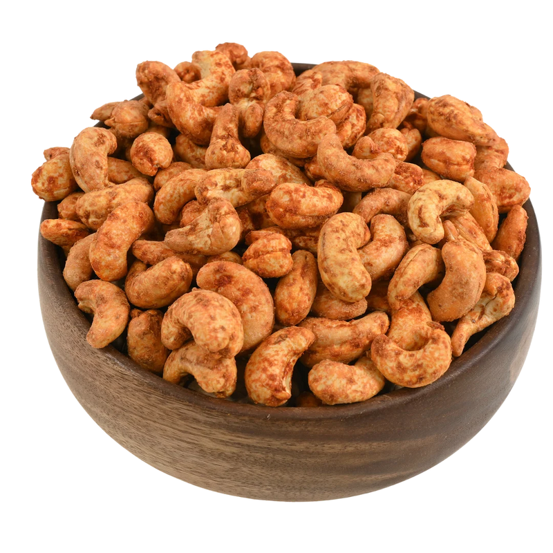 Premium red chilli flavoured cashews in a rustic wooden bowl, best spiced dry fruits online in Bangalore from House of Rasda, rich in crunch and taste.